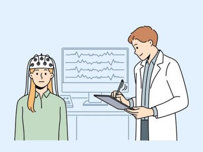 A researcher collecting EEG data from a research participant and noting down relevant behavioral observations.